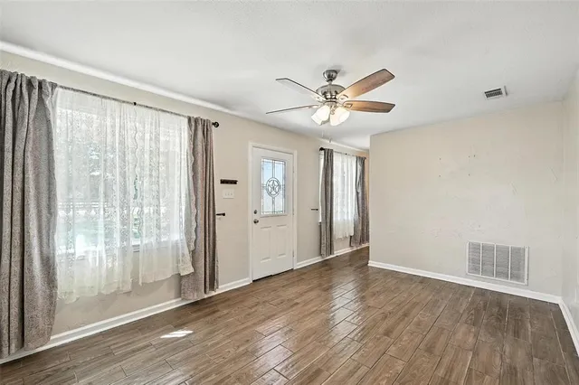 a view of an empty room and wooden floor