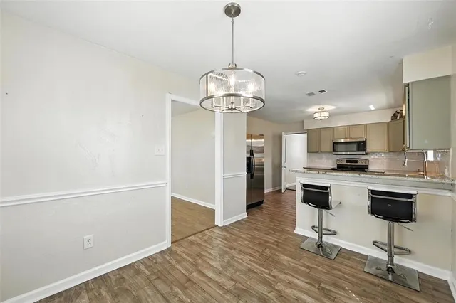 a kitchen with stainless steel appliances a stove sink and microwave