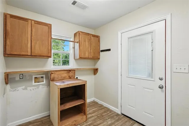 a view of empty room with wooden floor