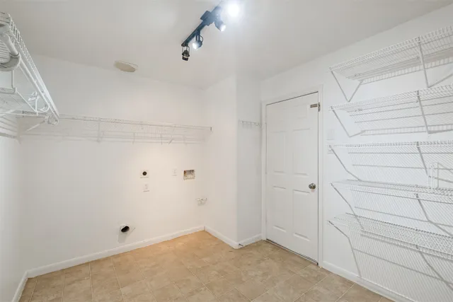 a kitchen with stainless steel appliances a sink a stove a microwave cabinets and a counter top space