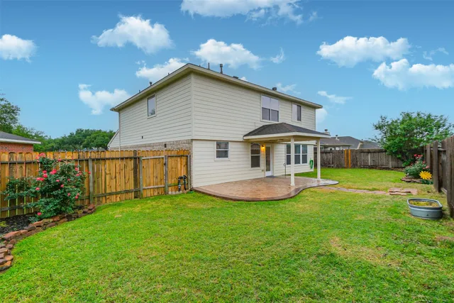 a view of backyard with wooden fence