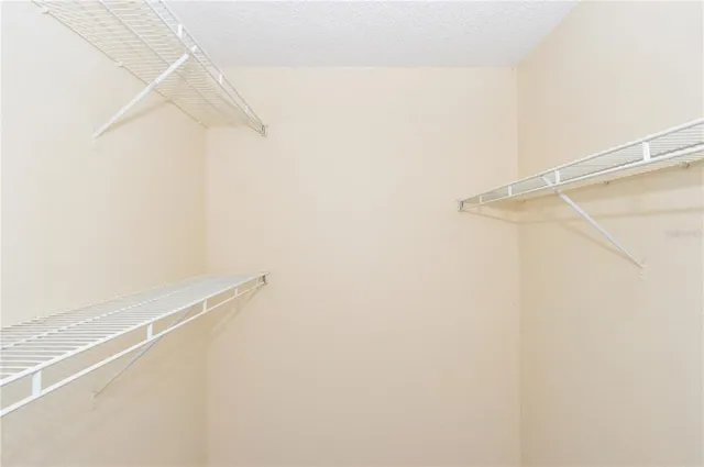 a front view of a house with a yard and potted plants