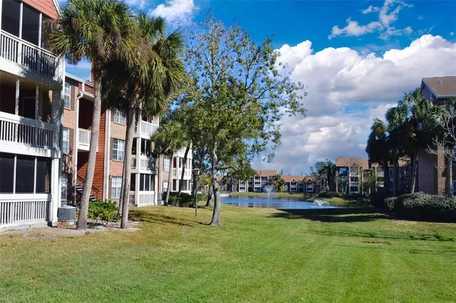 an aerial view of residential houses with outdoor space and swimming pool