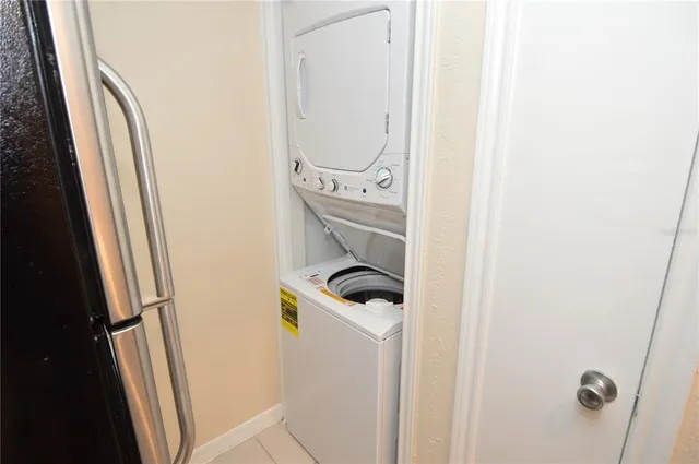 a kitchen with granite countertop a sink stove and refrigerator