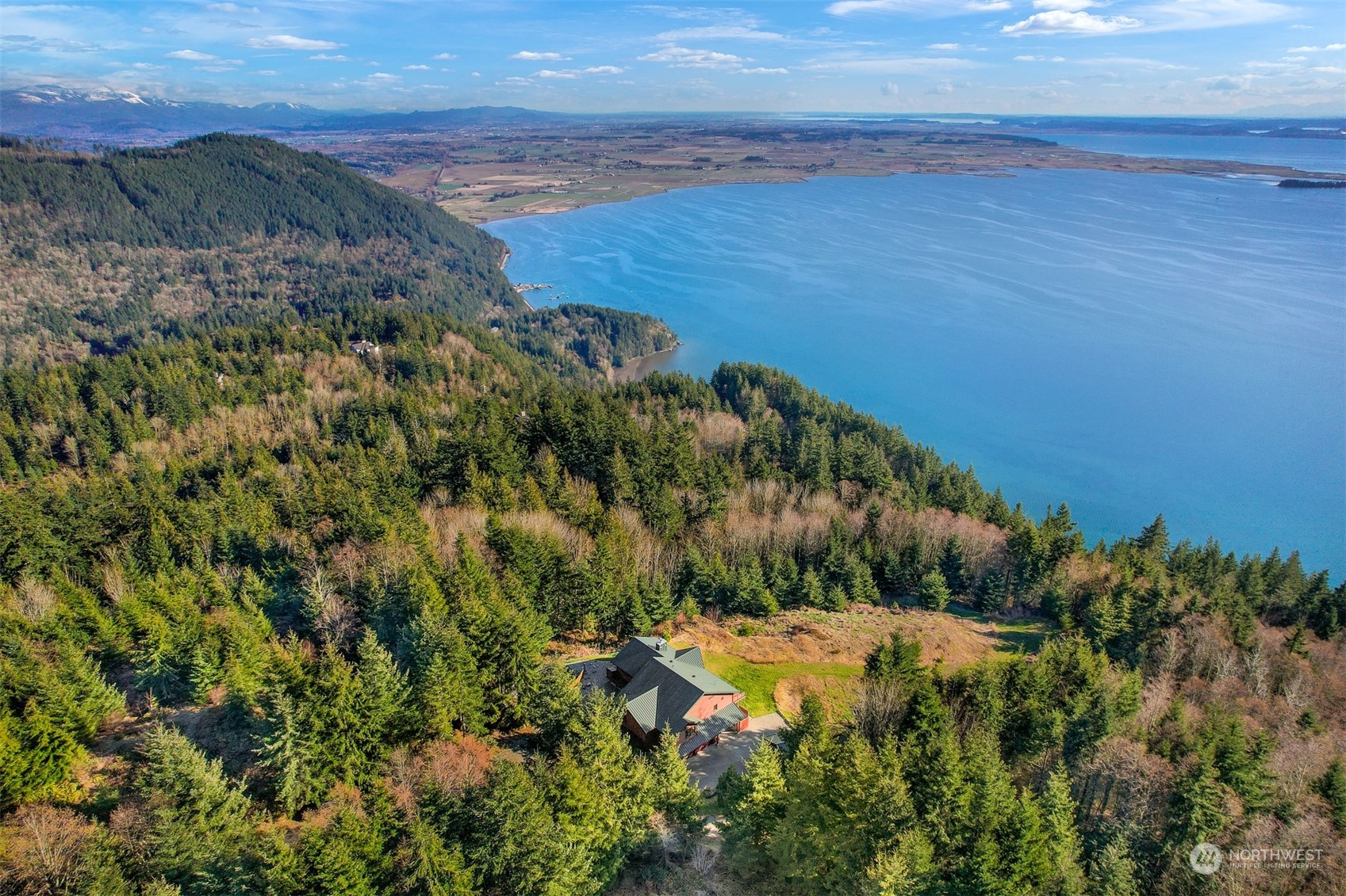 887 Chuckanut Ridge Drive Bow, WA 98232 - Photo 27 of 35 a view of a lake with a yard