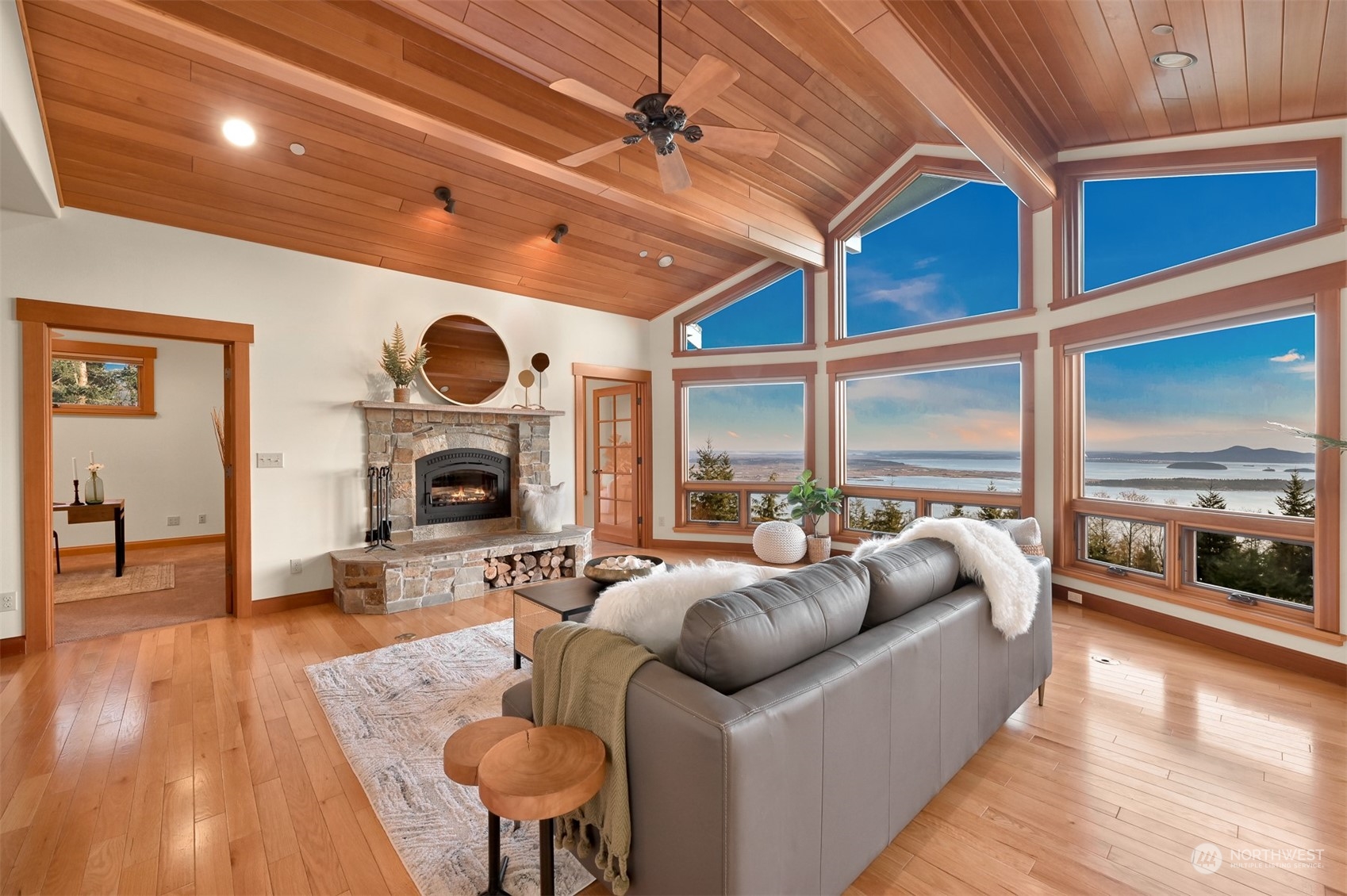 887 Chuckanut Ridge Drive Bow, WA 98232 - Photo 6 of 35 a living room with furniture a fireplace and a large window