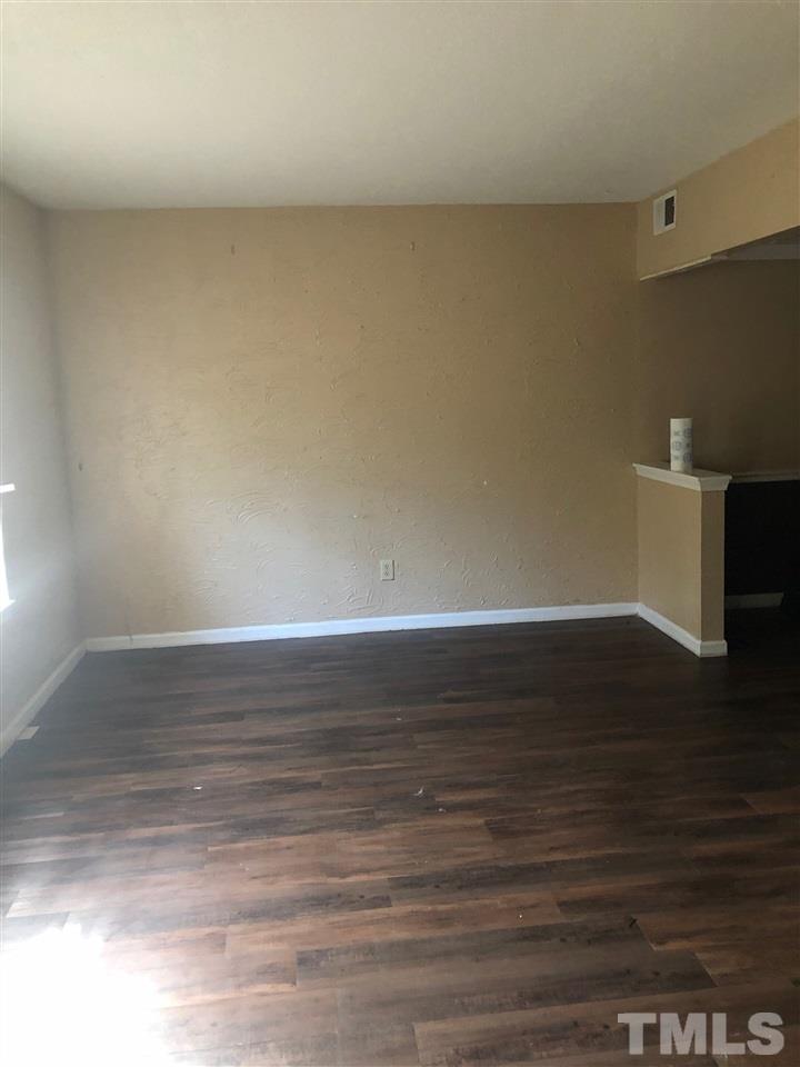 1328 Springlawn Court Raleigh, NC 27609 - Photo 2 of 6 a view of an empty room and wooden floor