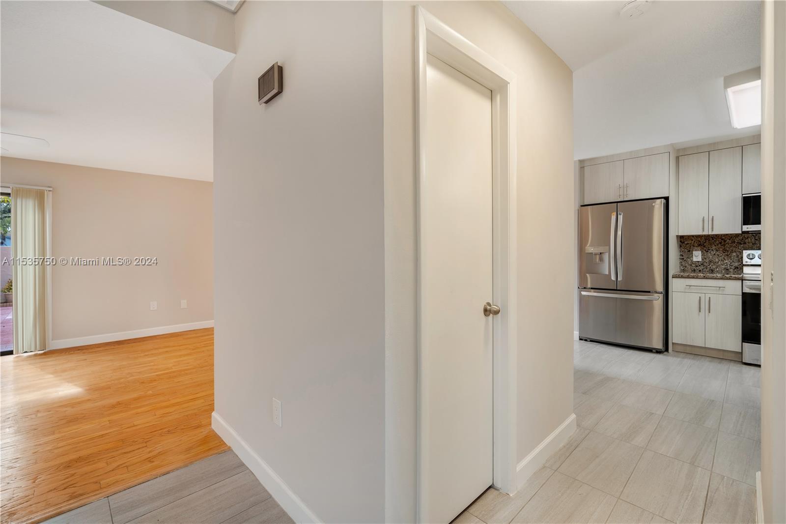 13225 Southwest 95th Avenue, Unit 13225 Miami, FL 33176 - Photo 12 of 36 a view of a refrigerator in kitchen and an empty room
