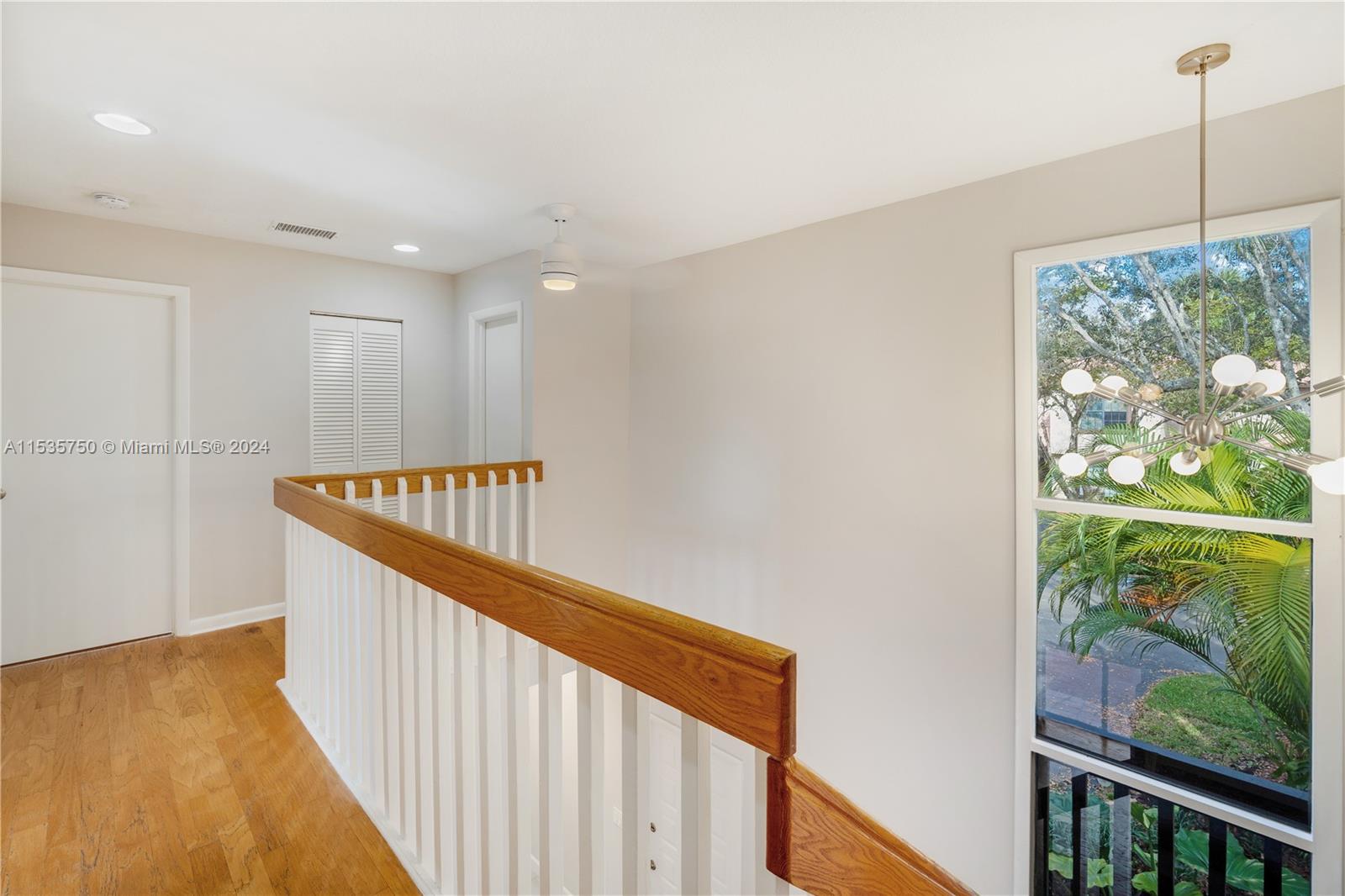 13225 Southwest 95th Avenue, Unit 13225 Miami, FL 33176 - Photo 16 of 36 a stairs and a window in an empty room