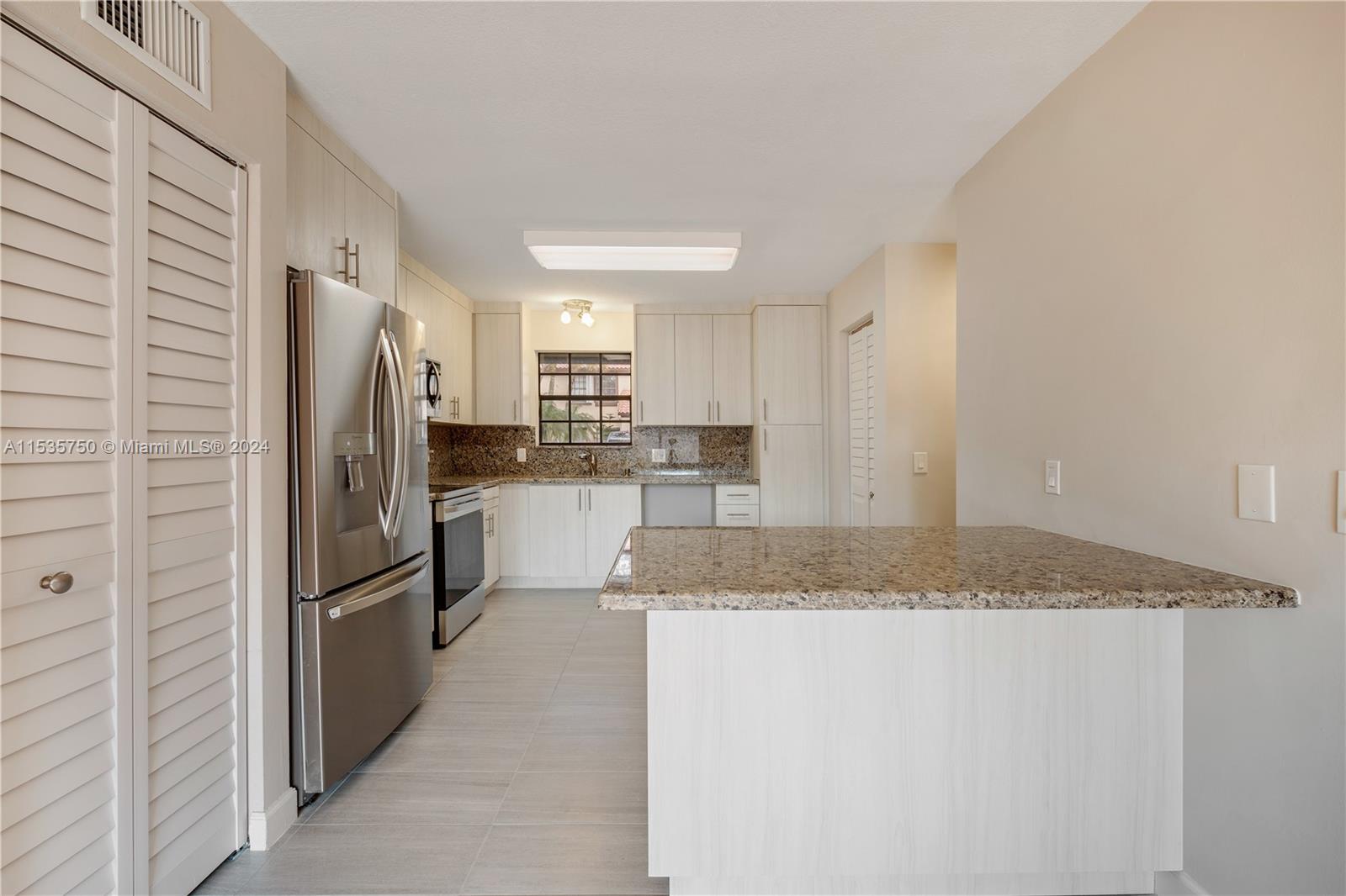 13225 Southwest 95th Avenue, Unit 13225 Miami, FL 33176 - Photo 2 of 36 a kitchen with stainless steel appliances granite countertop a refrigerator and a sink