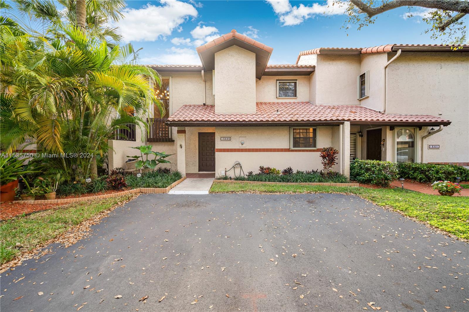 13225 Southwest 95th Avenue, Unit 13225 Miami, FL 33176 - Photo 29 of 36 a front view of house with a garden and parking
