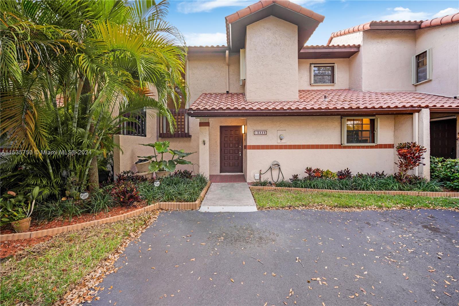 13225 Southwest 95th Avenue, Unit 13225 Miami, FL 33176 - Photo 30 of 36 a front view of house with yard and green space