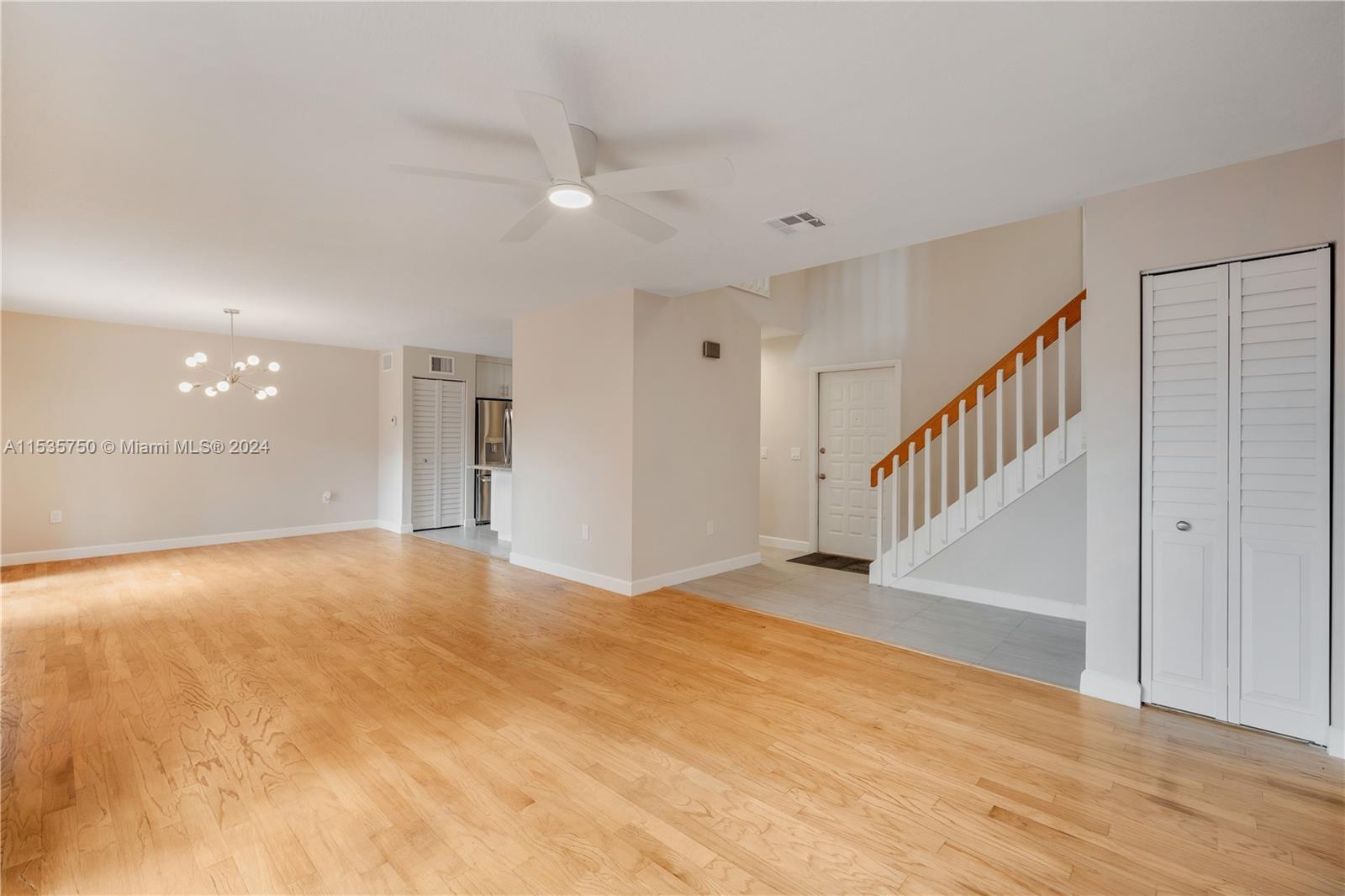 13225 Southwest 95th Avenue, Unit 13225 Miami, FL 33176 - Photo 10 of 36 a view of an empty room with wooden floor and entryway