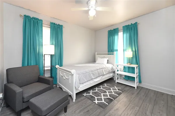 a bedroom with a bed couch and a window