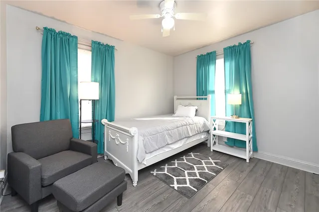 a bedroom with a bed couch and a window