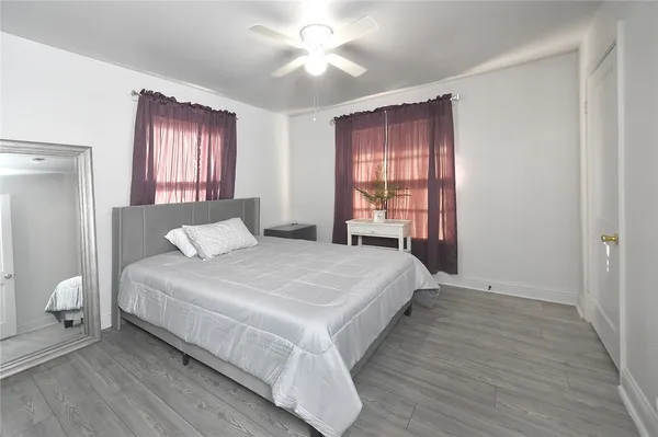 a bedroom with a bed and window