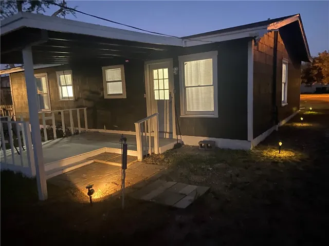 a view of a house with backyard and porch