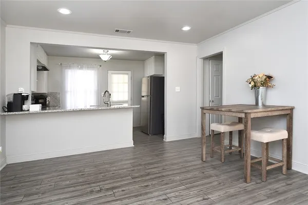 a living room with kitchen island furniture and a wooden floor