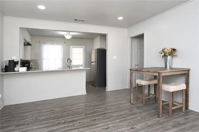 a living room with kitchen island furniture and a wooden floor