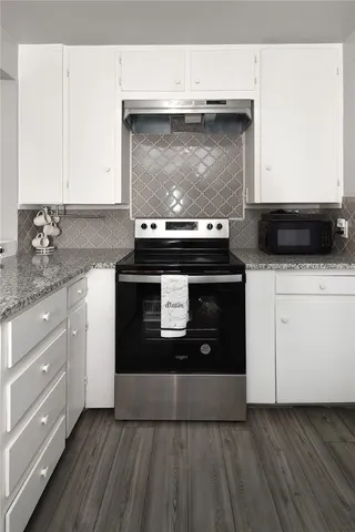 a stove top oven sitting inside of a kitchen