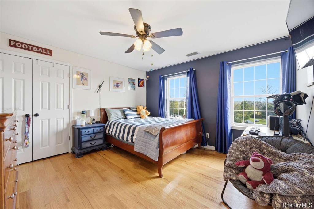 133 Old Chester Road Goshen, NY 10924 - Photo 22 of 33 a spacious bedroom with a bed and a chandelier