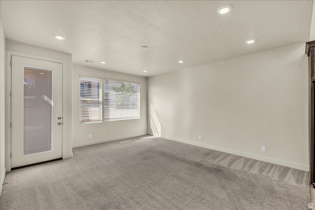 794 North Via Modelo Circle Washington, UT 84780 - Photo 15 of 21 Spare room featuring light carpet, a textured ceiling, and recessed lighting
