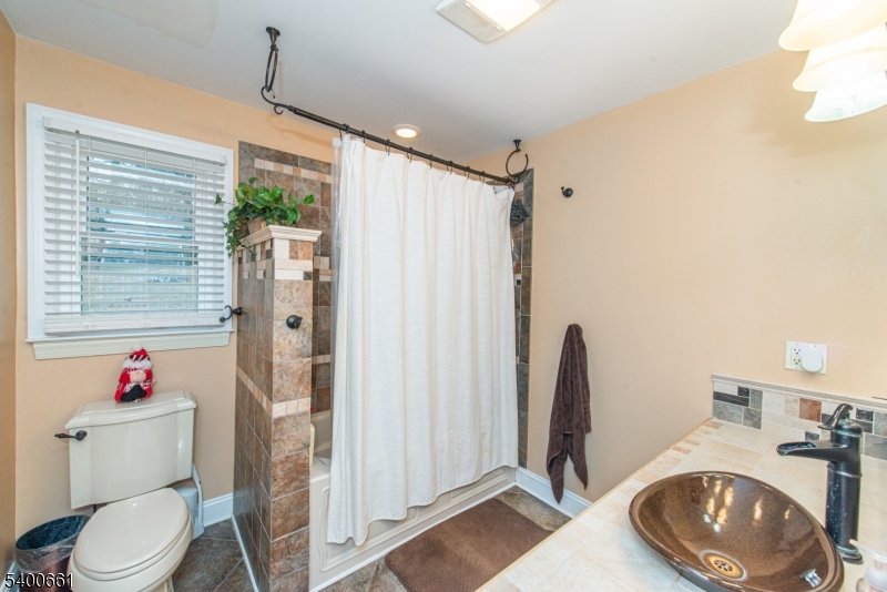 131 Taylortown Road Montville, NJ 07005 - Photo 12 of 26 a bathroom with a toilet a sink and a shower