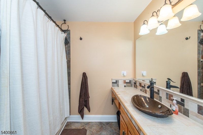 131 Taylortown Road Montville, NJ 07005 - Photo 13 of 26 a bathroom with a double vanity sink and a mirror