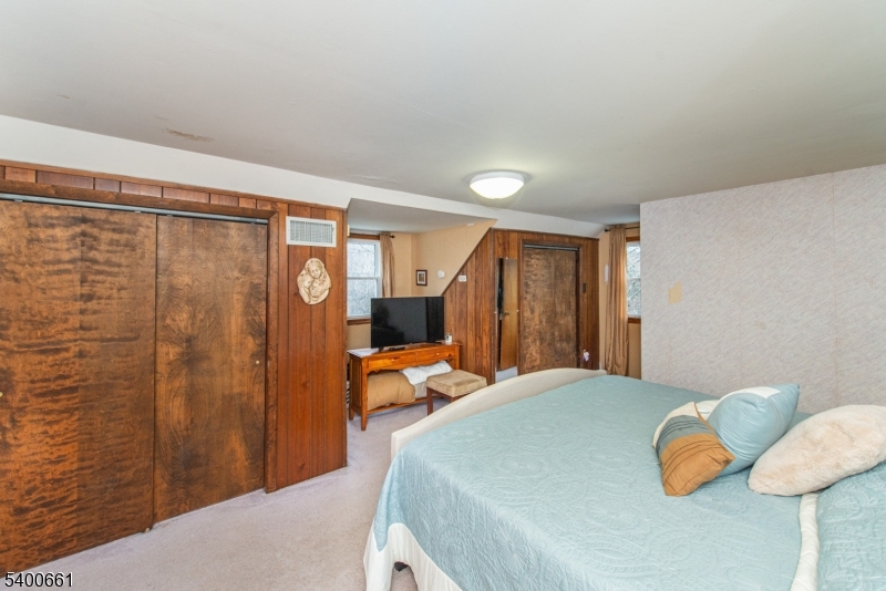 131 Taylortown Road Montville, NJ 07005 - Photo 16 of 26 a bedroom with a bed and wooden floor