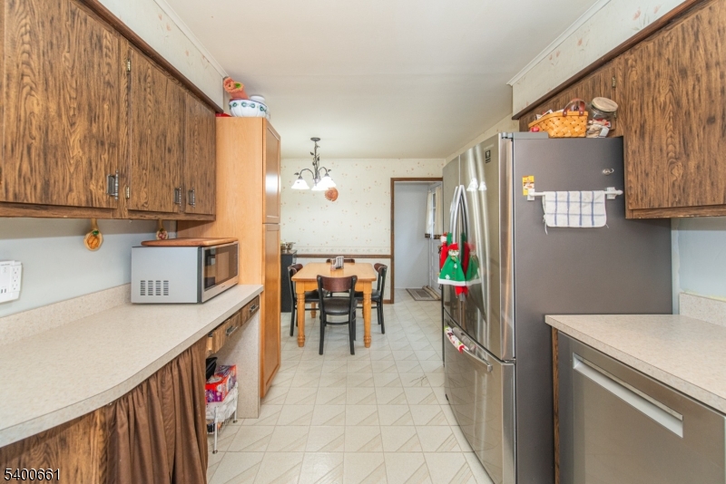 131 Taylortown Road Montville, NJ 07005 - Photo 9 of 26 a kitchen filled with a dining table chairs appliances and cabinets