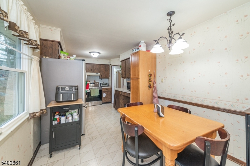 131 Taylortown Road Montville, NJ 07005 - Photo 10 of 26 a view of kitchen and dining area with chandelier
