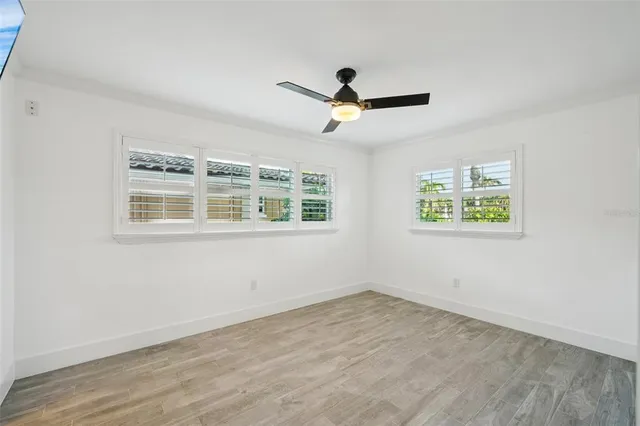 a bathroom with a granite countertop sink and a window