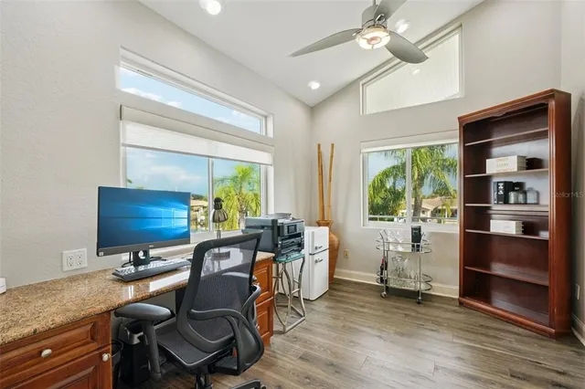a bathroom with a granite countertop tub shower and sink