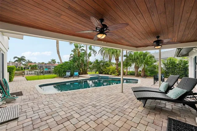 a view of a house with swimming pool and sitting area