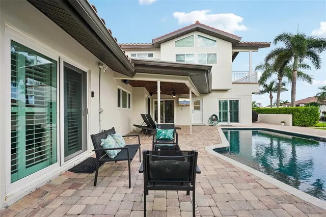 a front view of a house with a yard and potted plants