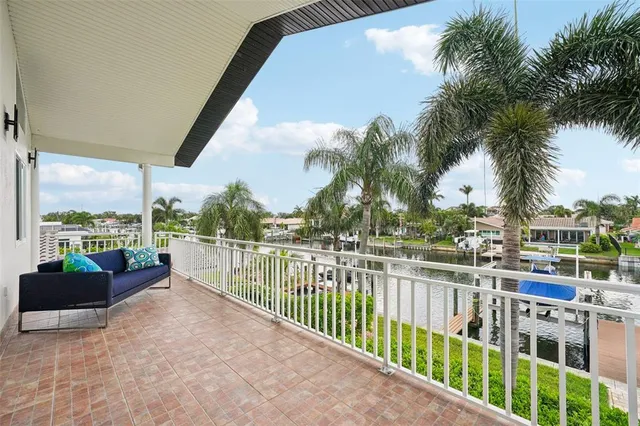 a small pool with couple of palm trees