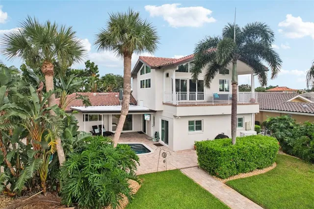 a front view of a house with a yard and a garage