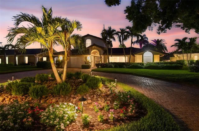 a view of a house with a yard and potted plants
