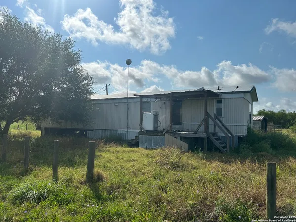 a backyard of a house with table and chairs