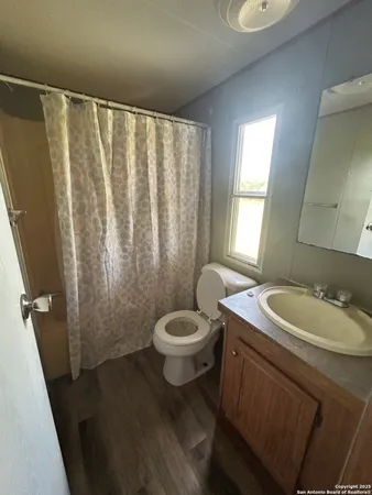 a bathroom with a sink a toilet and a mirror