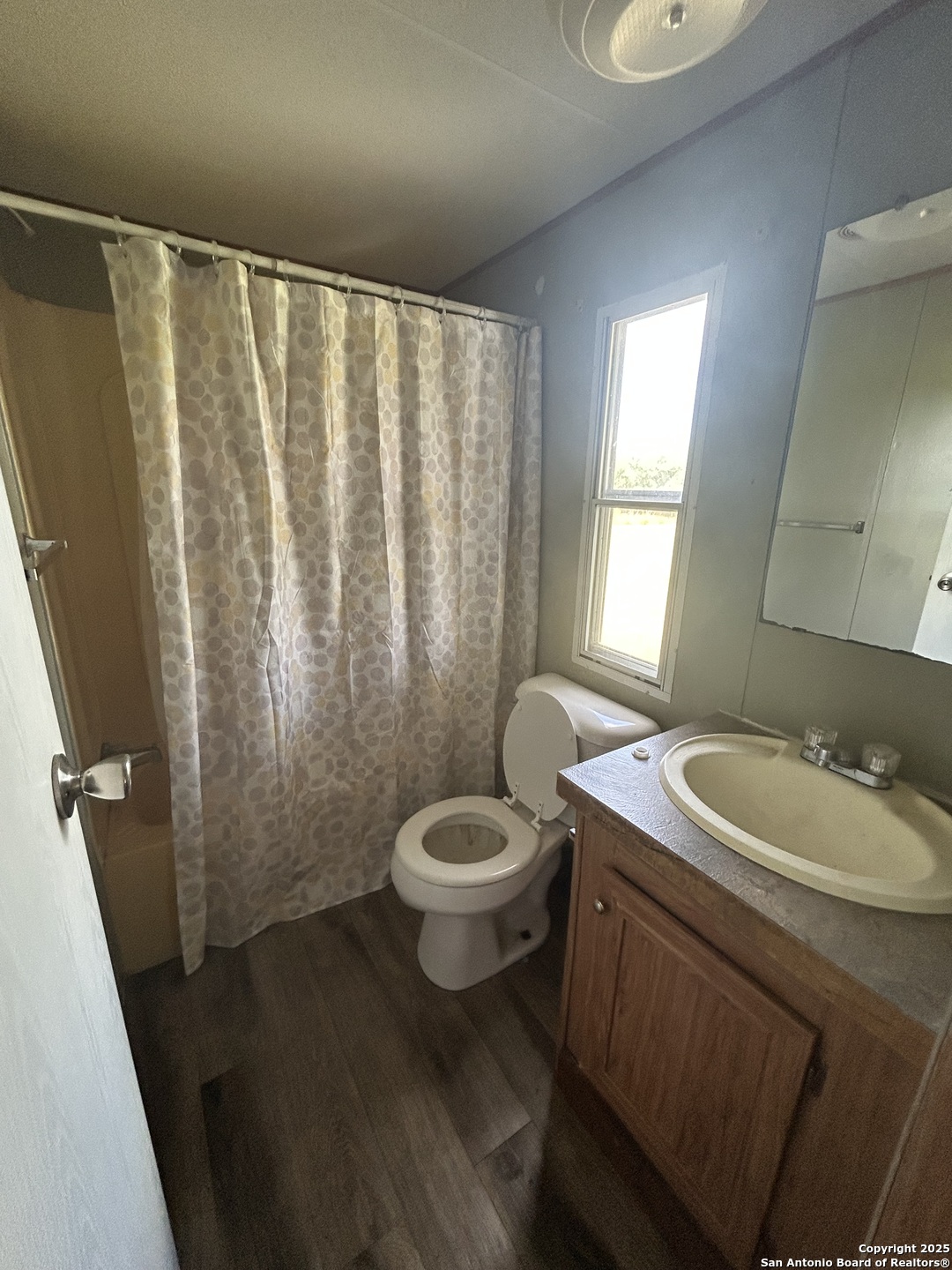 1242 Cologne Road Victoria, TX 77905 - Photo 11 of 29 a bathroom with a sink a toilet and a mirror