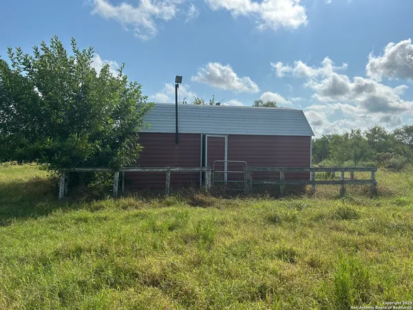 a backyard of a house with lots of green space and lake view