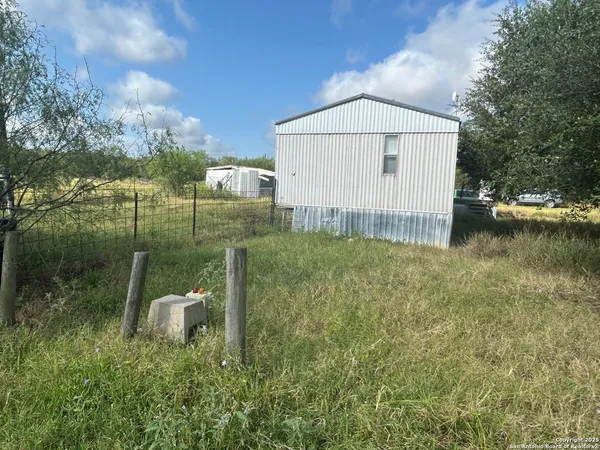 a view of a backyard with a garden and plants