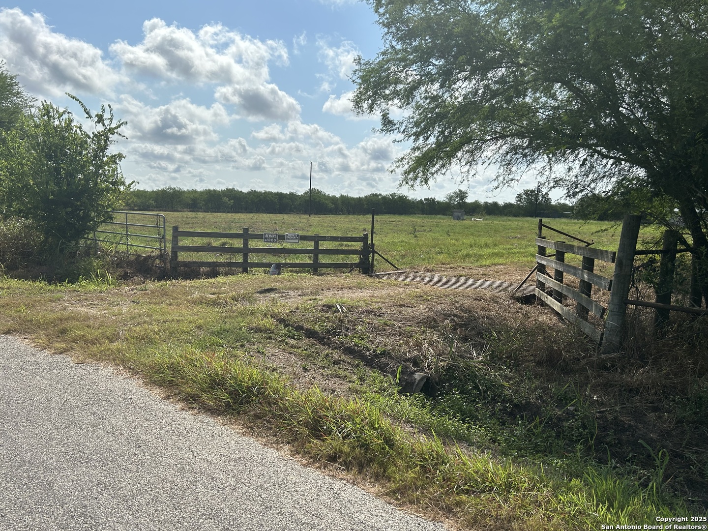 1242 Cologne Road Victoria, TX 77905 - Photo 27 of 29 a view of a lake with a bench and trees