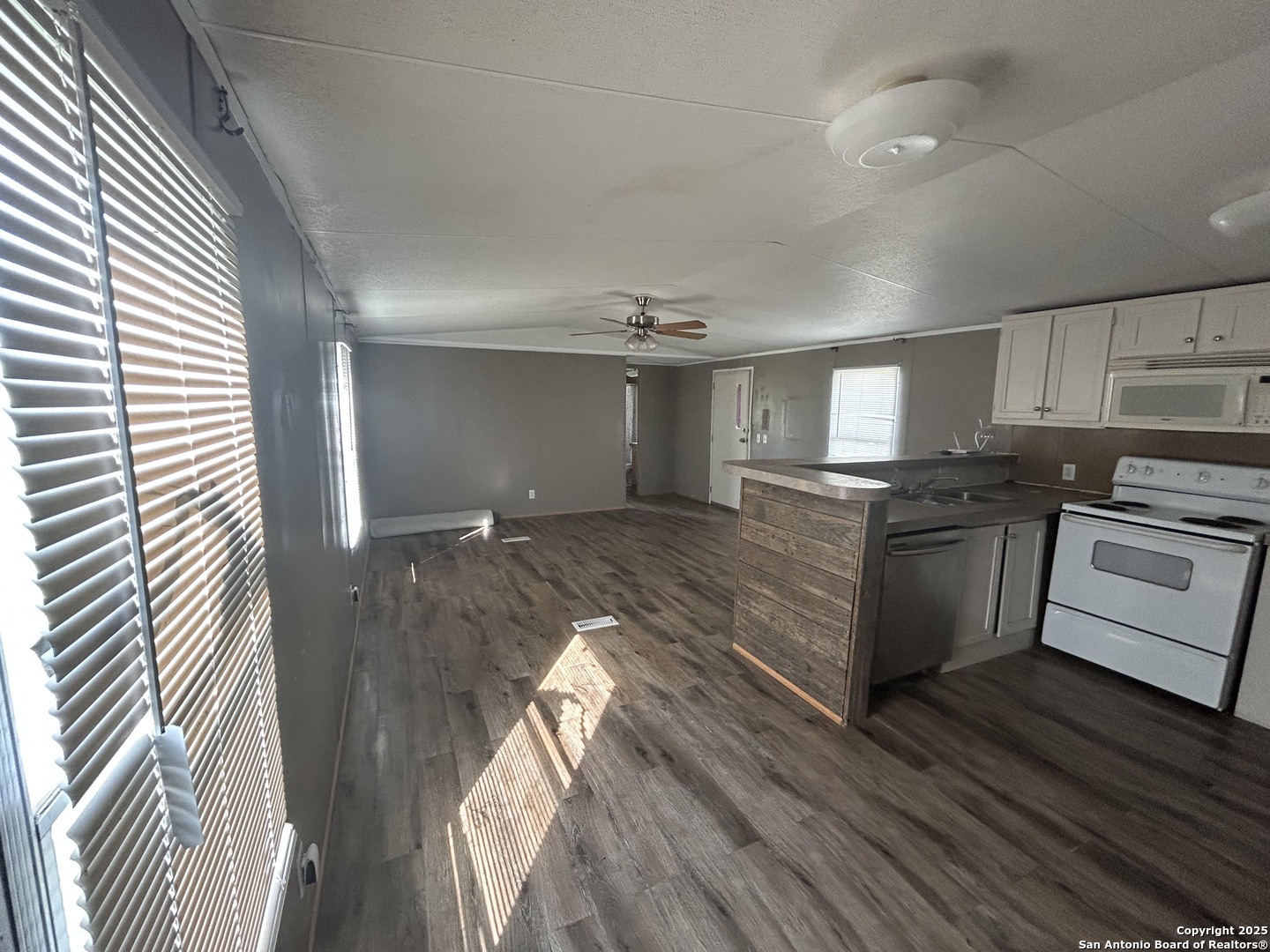 1242 Cologne Road Victoria, TX 77905 - Photo 3 of 29 a kitchen with granite countertop a sink cabinets stainless steel appliances and a window