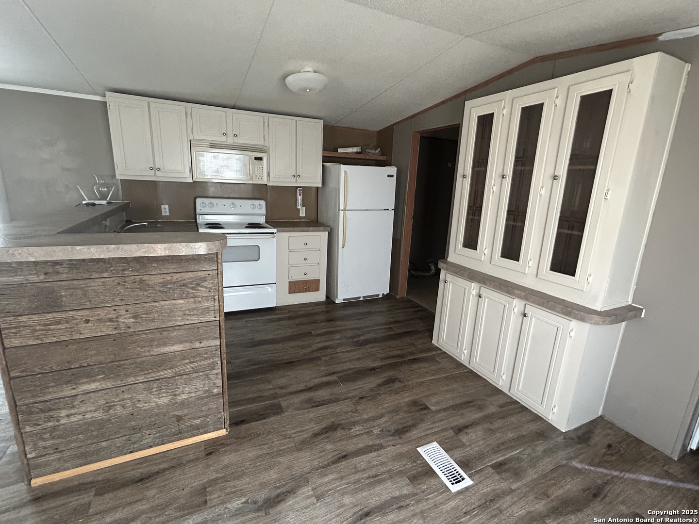 1242 Cologne Road Victoria, TX 77905 - Photo 4 of 29 a kitchen with granite countertop white cabinets and stainless steel appliances