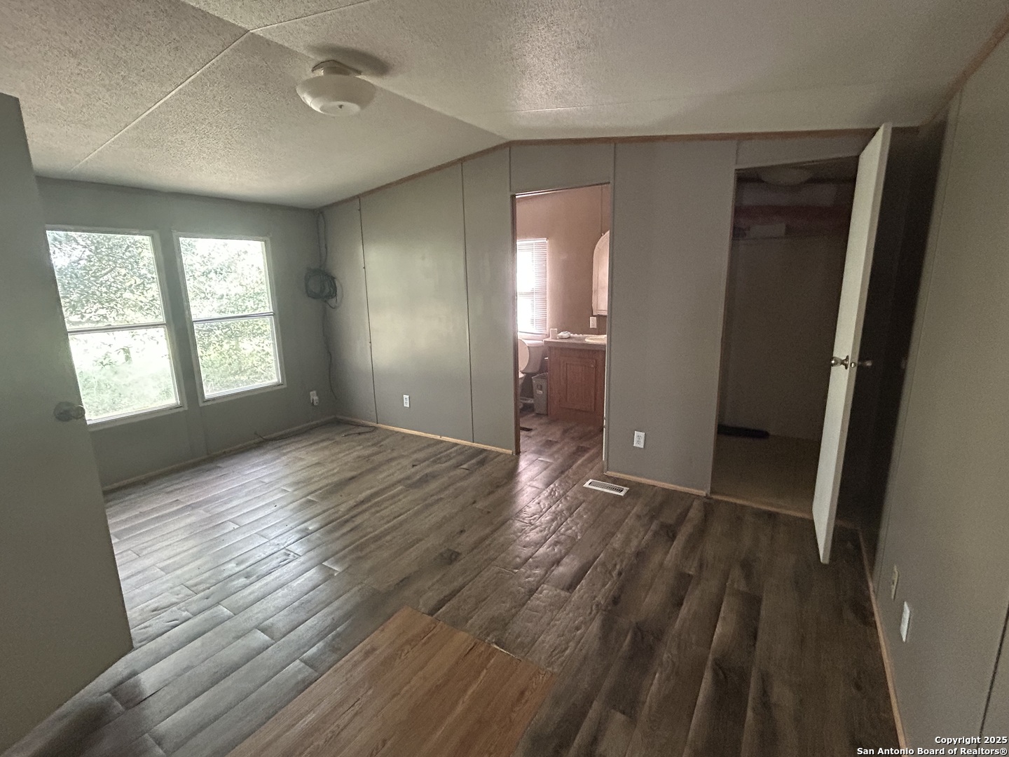 1242 Cologne Road Victoria, TX 77905 - Photo 5 of 29 wooden floor in an empty room with a window