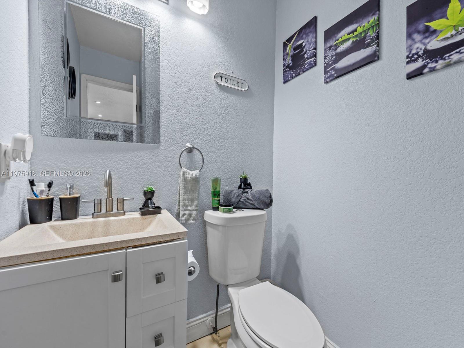 30236 Southwest 148th Place Homestead, FL 33033 - Photo 14 of 69 a bathroom with a toilet sink and mirror