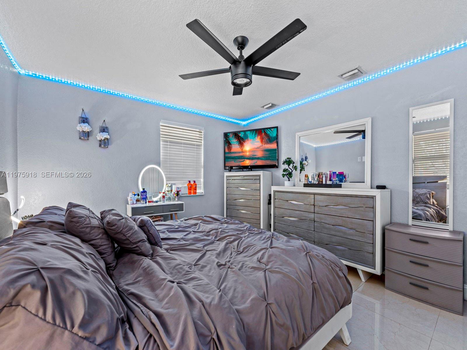 30236 Southwest 148th Place Homestead, FL 33033 - Photo 15 of 69 a bedroom with a bed and a flat screen tv