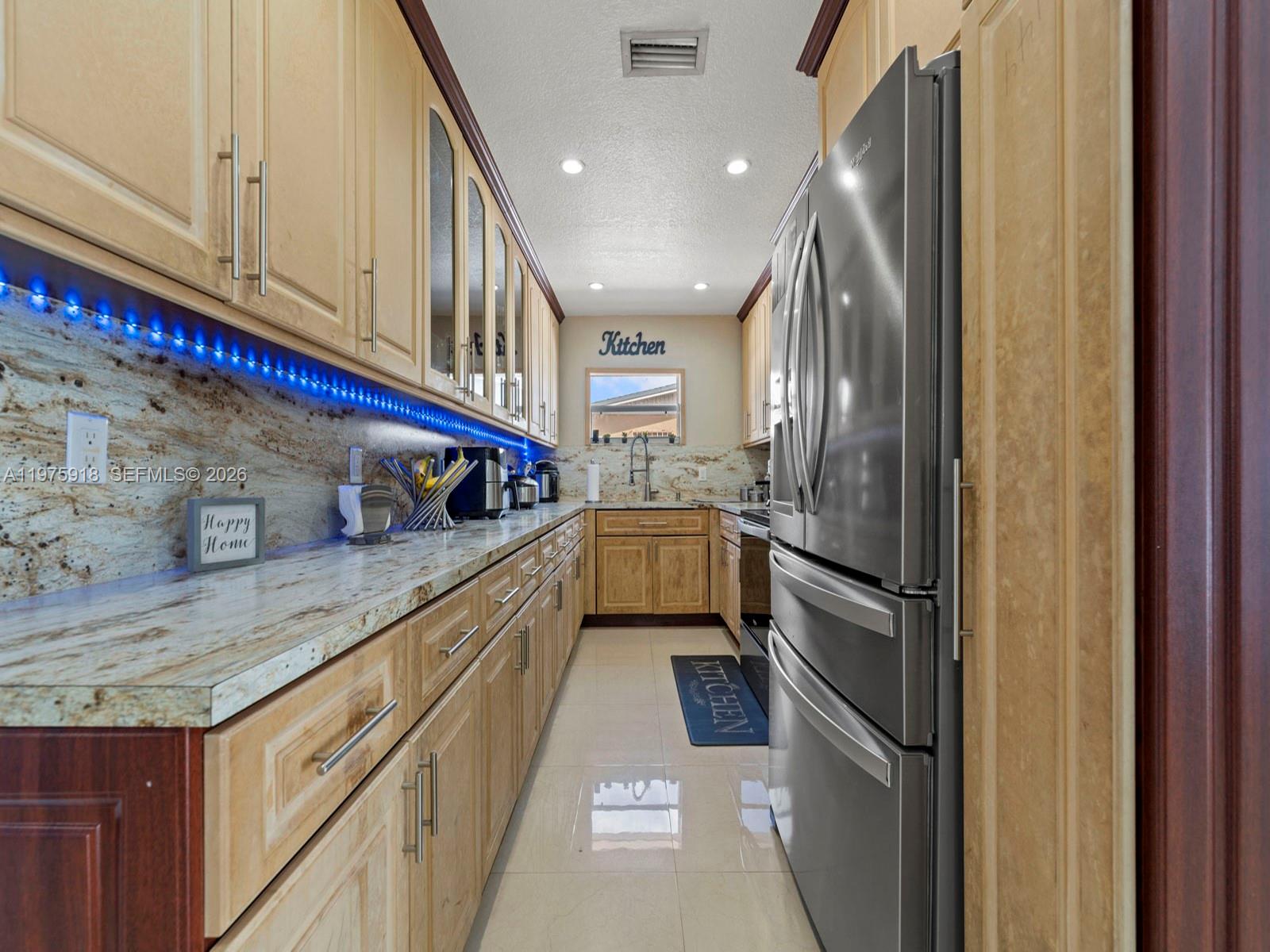 30236 Southwest 148th Place Homestead, FL 33033 - Photo 17 of 69 a kitchen with stainless steel appliances granite countertop a refrigerator and a sink